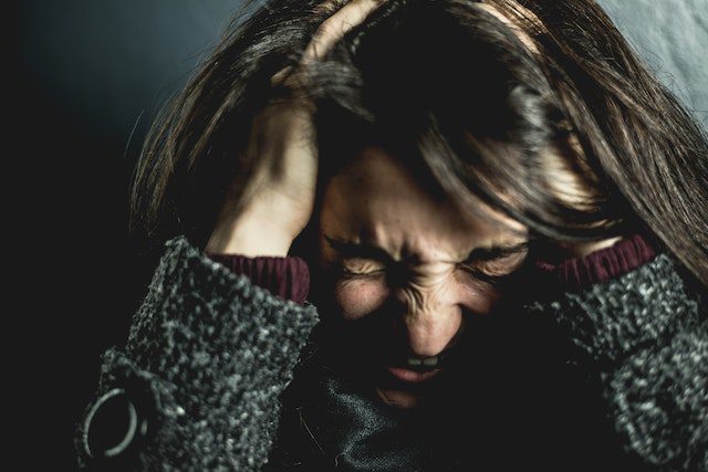 How to Deal With Stress Quickly woman holding her head