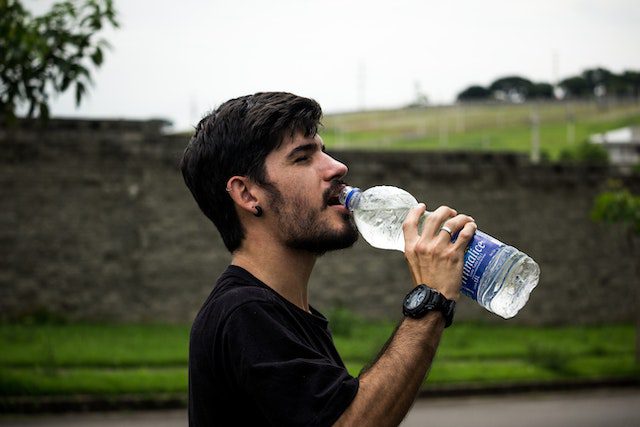 How much water should I drink everyday? Man drinking water