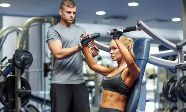 12 Week Full Body HIIT Workout with a trainer a lady on a machine